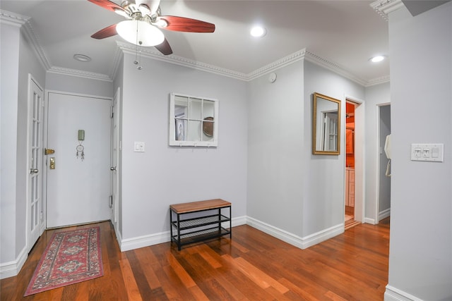 corridor with baseboards, recessed lighting, wood finished floors, and crown molding