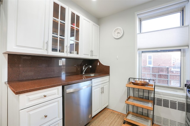 bar with dishwasher, backsplash, and a sink