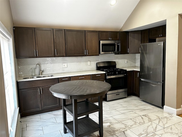 kitchen featuring marble finish floor, stainless steel appliances, dark brown cabinetry, vaulted ceiling, and a sink