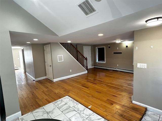 interior space with baseboards, visible vents, stairway, and baseboard heating