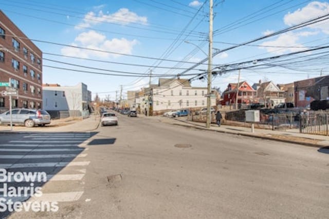 view of road featuring sidewalks, street lights, and curbs