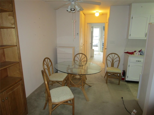 carpeted dining area featuring a ceiling fan