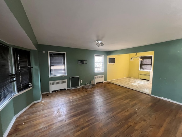 interior space with wood finished floors and radiator