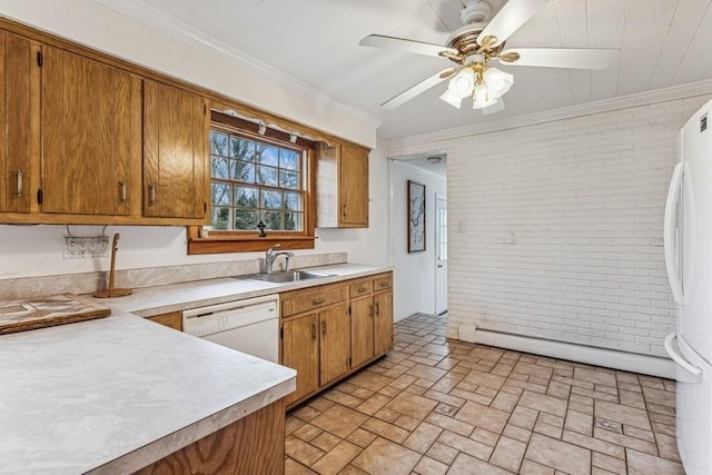 kitchen featuring brick wall, white appliances, a sink, light countertops, and ornamental molding