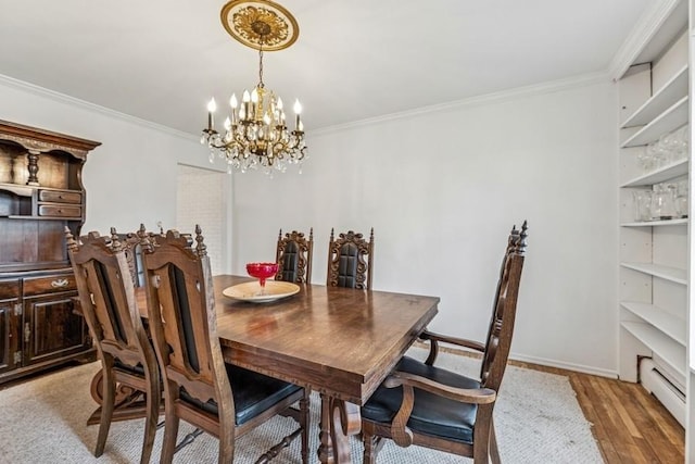 dining room featuring a chandelier, a baseboard radiator, baseboards, light wood finished floors, and crown molding