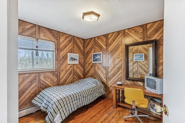 bedroom featuring wood walls and wood finished floors