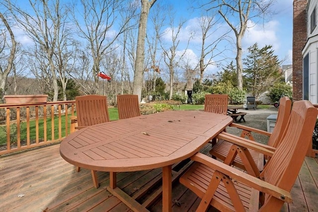 wooden terrace featuring outdoor dining space