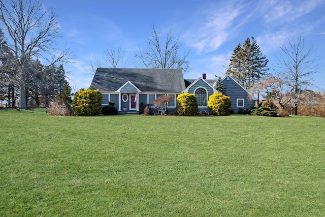 view of front facade featuring a chimney and a front yard