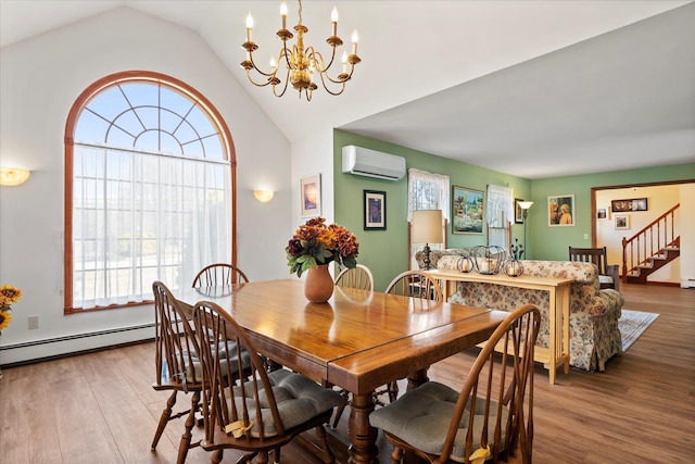 dining area with a wall unit AC, a baseboard radiator, a notable chandelier, wood finished floors, and stairway