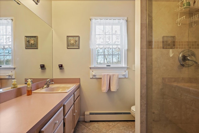 bathroom featuring tiled shower, toilet, tile patterned flooring, vanity, and a baseboard heating unit