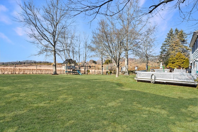 view of yard featuring a playground and a wooden deck