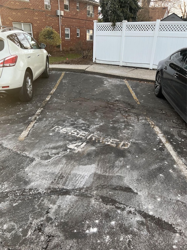 uncovered parking lot featuring fence