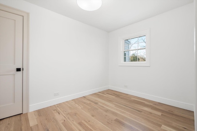 empty room featuring baseboards and wood finished floors