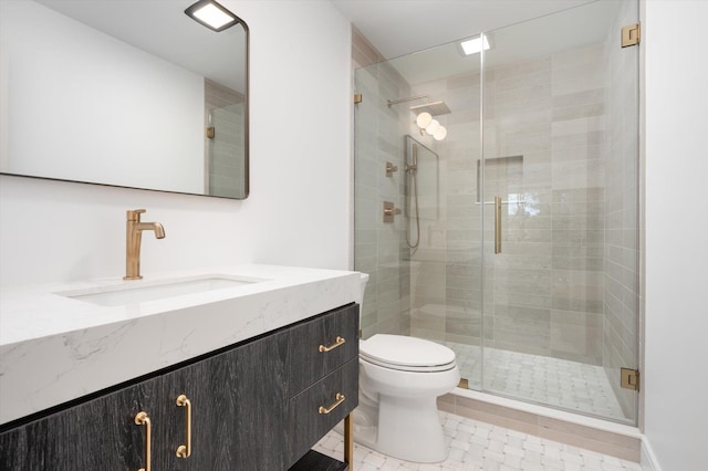 bathroom with a shower stall, toilet, and vanity