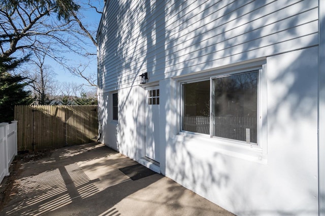 view of home's exterior featuring a patio area and fence