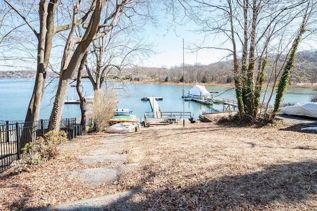 dock area featuring a water view and fence