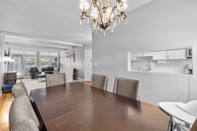 dining space featuring beamed ceiling