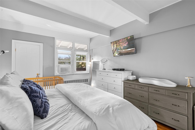 bedroom with radiator and beamed ceiling