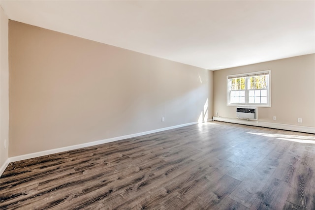 interior space featuring dark wood-style floors, baseboard heating, baseboards, and a wall mounted AC