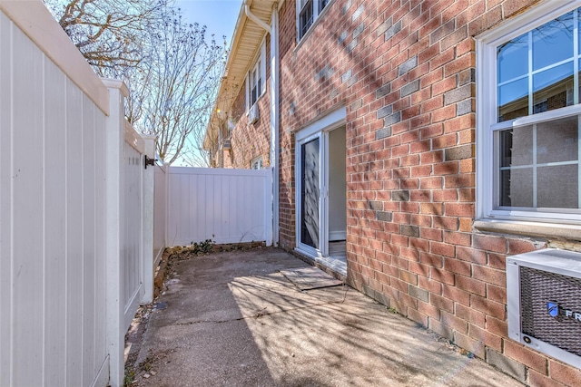 view of patio / terrace with heating unit and fence