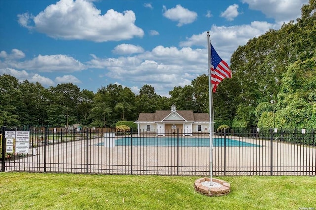 community pool featuring a yard, a patio area, and fence