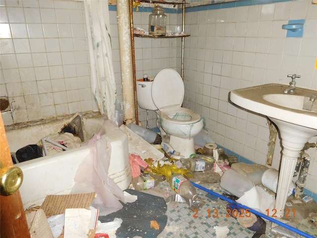 full bathroom featuring toilet and tile walls