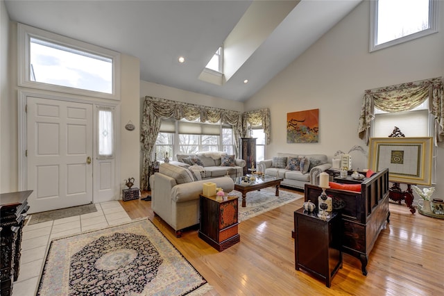 living room with a skylight, a healthy amount of sunlight, and light wood-style flooring