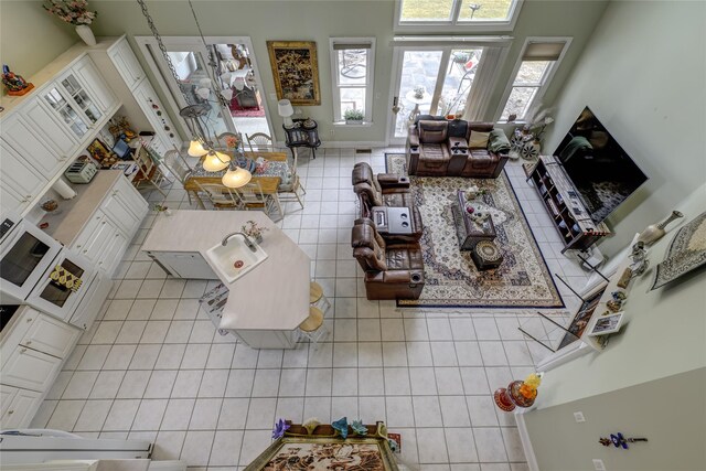 living room with tile patterned flooring and baseboards