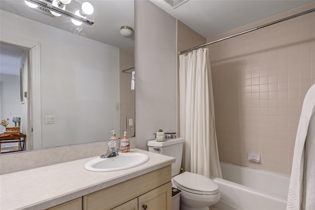 full bath with visible vents, shower / tub combo, vanity, and toilet