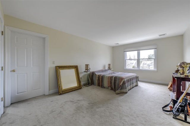 bedroom with carpet floors, baseboards, and visible vents