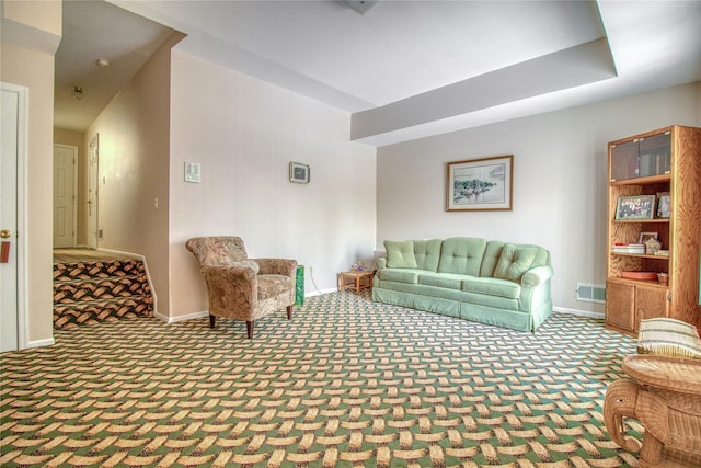 living room featuring carpet, visible vents, and baseboards