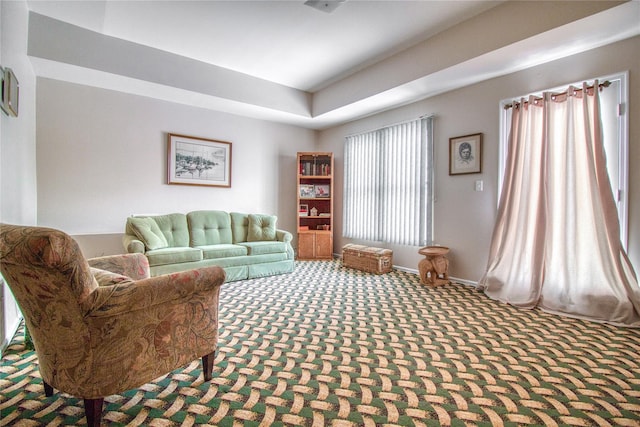 sitting room featuring carpet floors and baseboards