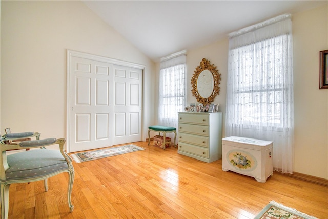 sitting room featuring hardwood / wood-style flooring and vaulted ceiling