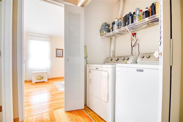 laundry area featuring laundry area, separate washer and dryer, and light wood finished floors