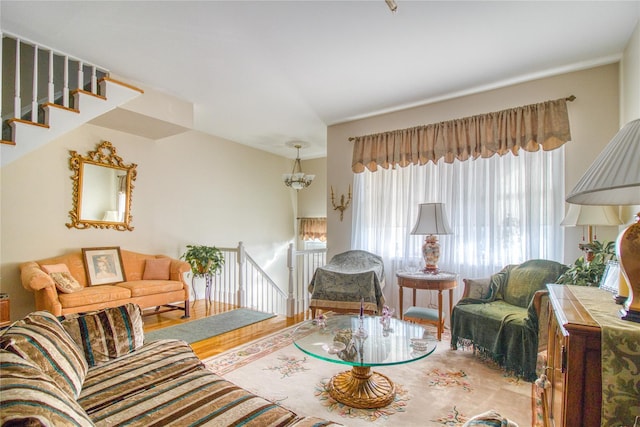 living room featuring wood finished floors and a notable chandelier