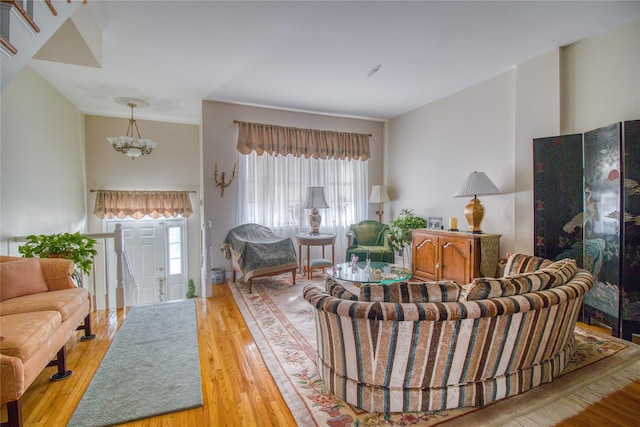 living room with a chandelier and wood finished floors