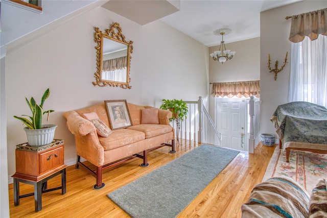 living room with an inviting chandelier and wood finished floors