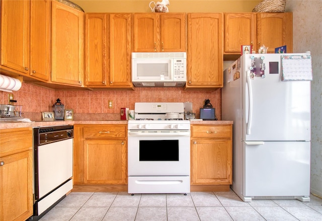 kitchen with light countertops, white appliances, light tile patterned flooring, and tasteful backsplash