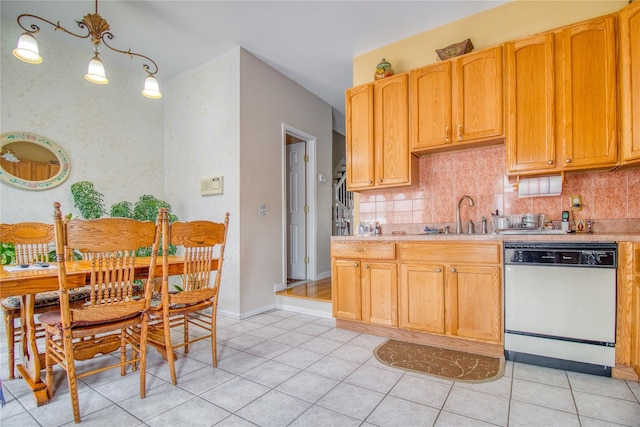 kitchen with light tile patterned floors, tasteful backsplash, dishwasher, light countertops, and a sink