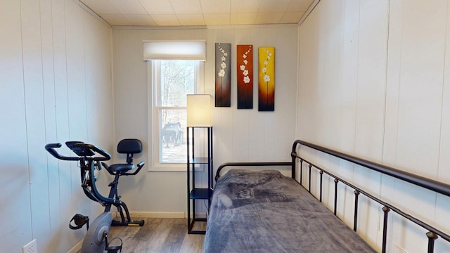 bedroom featuring baseboards and wood finished floors