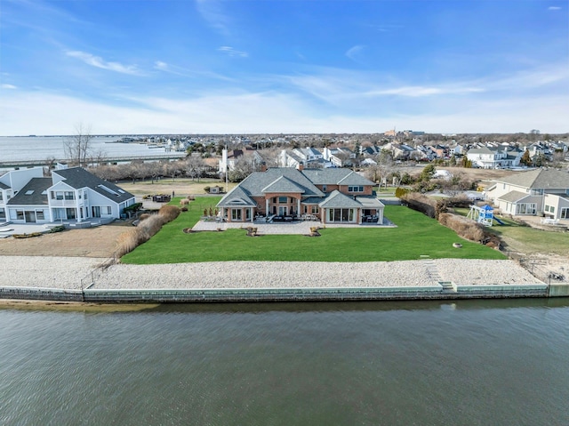 birds eye view of property featuring a water view and a residential view