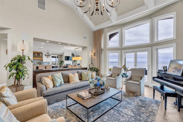 living room with recessed lighting, wood finished floors, visible vents, and an inviting chandelier