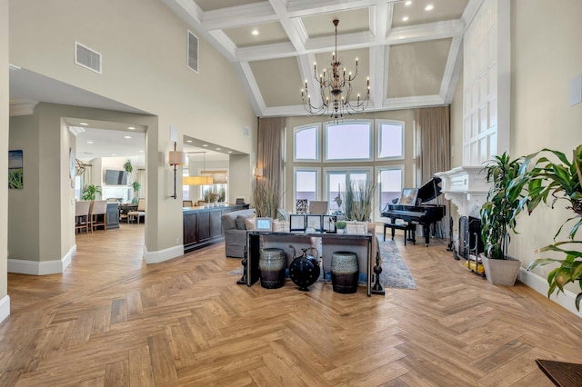 interior space featuring baseboards, visible vents, a towering ceiling, a notable chandelier, and recessed lighting