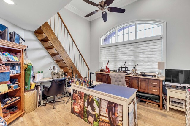 home office with light wood-type flooring, ceiling fan, and ornamental molding