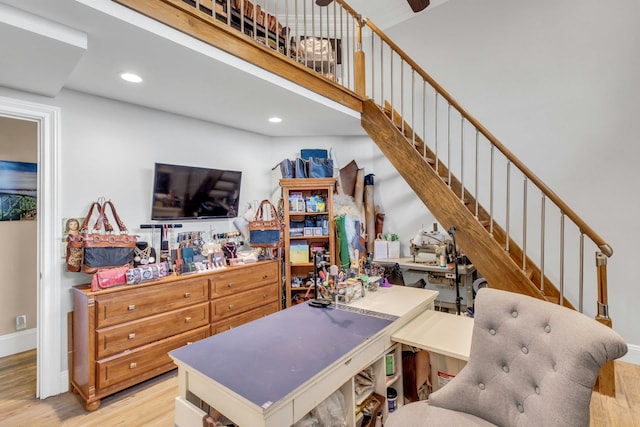 office featuring recessed lighting, baseboards, a high ceiling, and wood finished floors