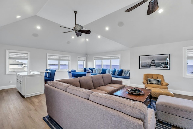 living area featuring light wood finished floors, plenty of natural light, and a ceiling fan