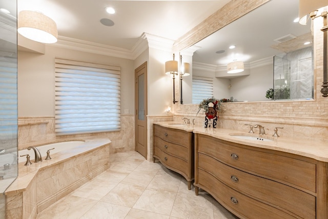 full bathroom with double vanity, a bath, a wainscoted wall, ornamental molding, and a sink