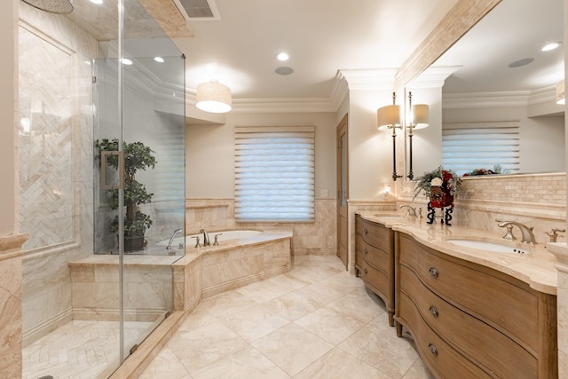 full bath featuring crown molding, a stall shower, a sink, and a bath