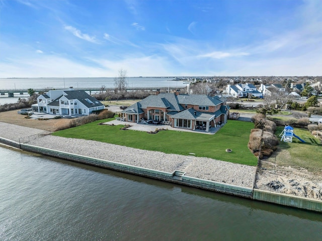 drone / aerial view with a water view and a residential view