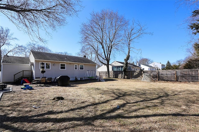 back of property with a patio area and fence